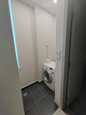 a small bathroom with a washing machine in it at Straits Garden Suites Serenity Springs in Jelutong