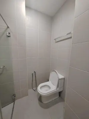 a bathroom with a toilet and a shower at Straits Garden Suites Serenity Springs in Jelutong