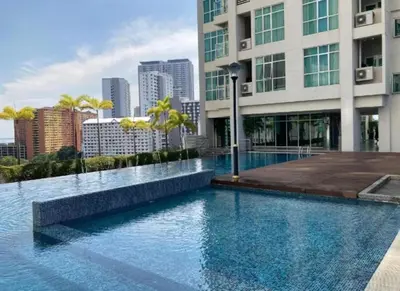 a large swimming pool in front of a building at Straits Garden Suites Serenity Springs in Jelutong