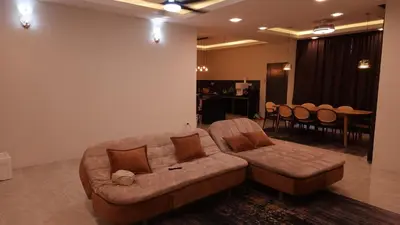 a brown couch in a living room with a table at Sastred villa Mus'lim Only in Sungai Petani