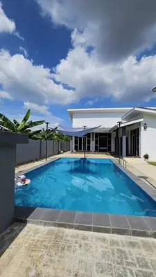 a large blue swimming pool in front of a house at Sastred villa Mus'lim Only in Sungai Petani