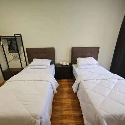 two beds sitting next to each other in a room at Sastred villa Mus'lim Only in Sungai Petani