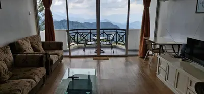 a living room with a couch and a glass table at FHCOMFYHOME B33A1 At SILVERPARK RESORT in Bukit Fraser