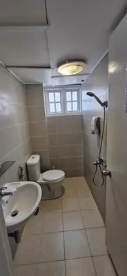 a bathroom with a toilet and a sink at FHCOMFYHOME B33A1 At SILVERPARK RESORT in Bukit Fraser
