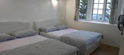 two beds sitting in a room with two windows at FHCOMFYHOME B33A1 At SILVERPARK RESORT in Bukit Fraser