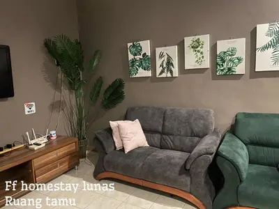 a living room with a couch and a chair at FF Lunas Homestay in Lunas