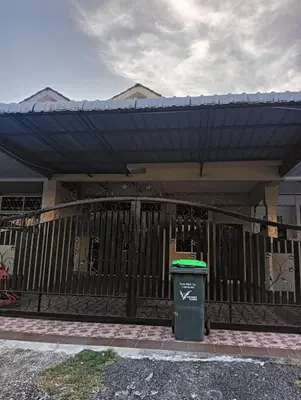 a black fence with a trash can in front of a house at FF Lunas Homestay in Lunas