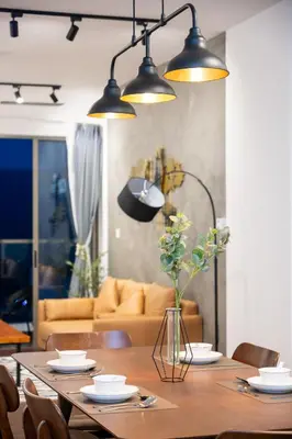a dining room with a table and three lights at Serene Industrial Family Retreat 2-7pax &Sunrise view in Brinchang