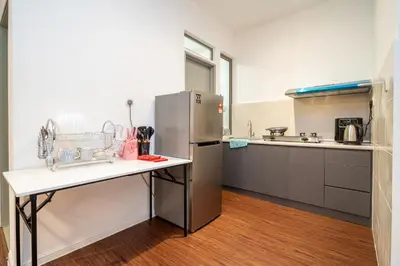 a kitchen with a stainless steel refrigerator and a counter at Serene Industrial Family Retreat 2-7pax &Sunrise view in Brinchang