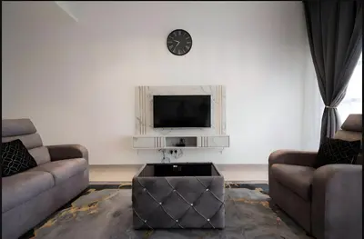 a living room with two couches and a tv at Serene Terrace House 2-12pax &Sunrise View in Brinchang