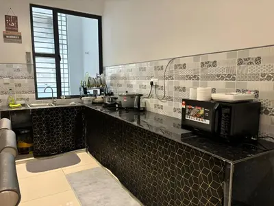 a kitchen with a counter top with a microwave at Serene Terrace House 2-12pax &Sunrise View in Brinchang