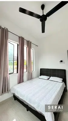 a bedroom with a bed and a ceiling fan at SERAI Homestay in Gopeng