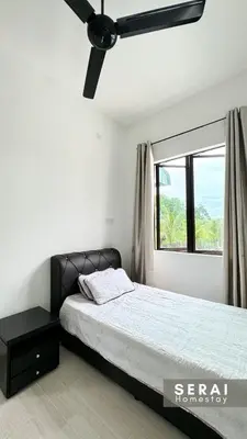 a bedroom with a bed and a window at SERAI Homestay in Gopeng
