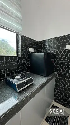 a kitchen counter with a toaster and a microwave at SERAI Homestay in Gopeng