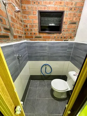 a bathroom with a toilet and a window at Bola-Bola DHomestay in Kepala Batas