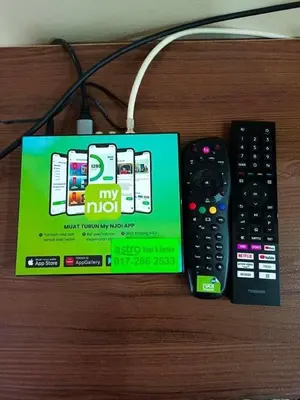 a box and two remote controls sitting on a table at Airis Homestay Bertam Perdana in Kepala Batas