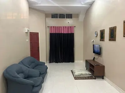 a living room with two chairs and a television at Airis Homestay Bertam Perdana in Kepala Batas