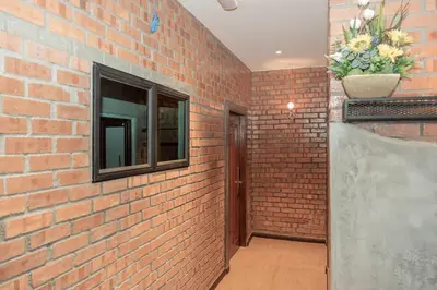 a brick hallway with a window and a brick wall at Bricks Guesthouse in Tanah Rata