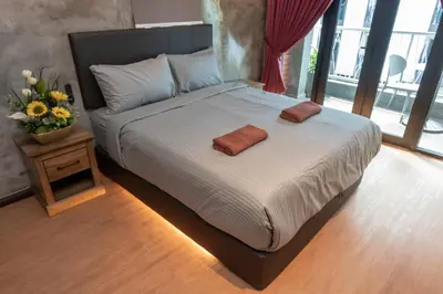 a bed with two pillows on it in a bedroom at Bricks Guesthouse in Tanah Rata