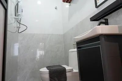 a bathroom with a toilet and a sink at Bricks Guesthouse in Tanah Rata