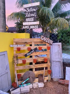 a building with a sign and some doors at Yellow Retreat House Homestay Batu Gajah in Batu Gajah