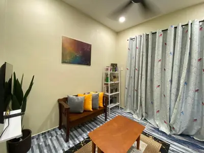 a living room with curtains and a couch at Yellow Retreat House Homestay Batu Gajah in Batu Gajah