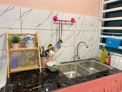 a kitchen with a sink and a counter top at Yellow Retreat House Homestay Batu Gajah in Batu Gajah