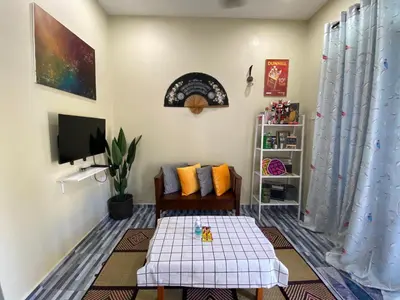 a living room with a couch and a table at Yellow Retreat House Homestay Batu Gajah in Batu Gajah