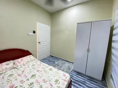 a small bedroom with a bed and a closet at Yellow Retreat House Homestay Batu Gajah in Batu Gajah