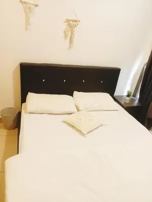 a white bed with two pillows on top of it at Palas Horizon Cameron Highland in Brinchang
