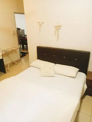 a white bed with two pillows on top of it at Palas Horizon Cameron Highland in Brinchang