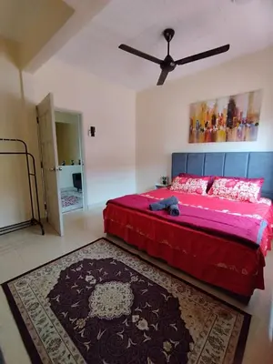 a bedroom with a large bed with a ceiling fan at Homestay Tasnim Bertam 5 Rooms Corner lot in Kepala Batas