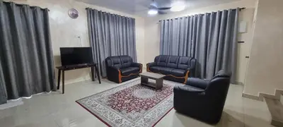 a living room with two chairs and a tv at Homestay Tasnim Bertam 5 Rooms Corner lot in Kepala Batas