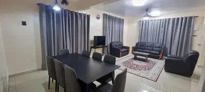 a dining room with a black table and chairs at Homestay Tasnim Bertam 5 Rooms Corner lot in Kepala Batas