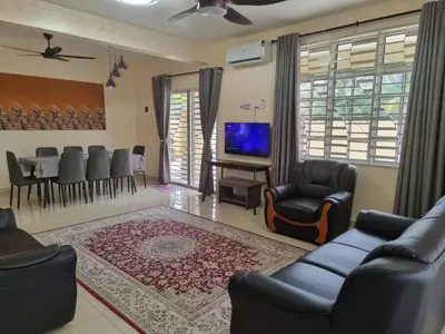 a living room with a couch and chairs and a television at Homestay Tasnim Bertam 5 Rooms Corner lot in Kepala Batas