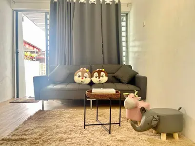 a living room with a couch with three faces on it at Cozy10perwira#6pax#Netflix#neariconcity&iconicpoint in Simpang Ampat
