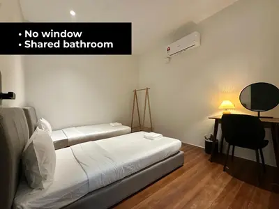 a room with a bed and a desk with a chair at Li's Inn in George Town