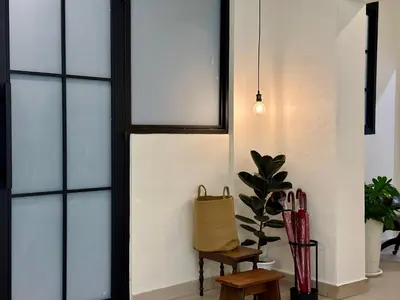 a room with windows and a chair and a plant at Li's Inn in George Town