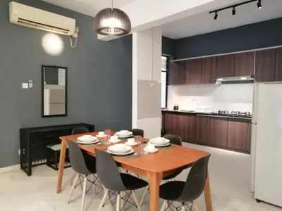 a kitchen and dining room with a wooden table and chairs at City Tropical Home II in George Town