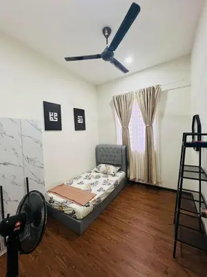 a living room with a couch and a ceiling fan at Inap Kasih Homestay Gua Musang Bandar Utama - Free Wifi, Netflix, Coway Provided in Gua Musang