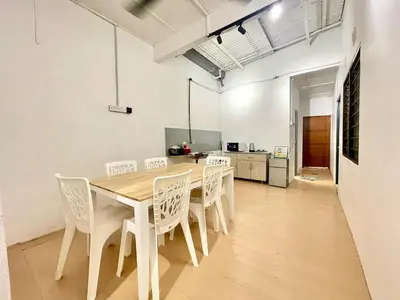 a dining room with a wooden table and chairs at Home10perwira#6pax#netflix#simpangampat#neariconicpoint in Simpang Ampat