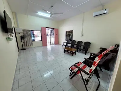 a waiting room with chairs and a table in a room at Pangkor Homestay in Pangkor