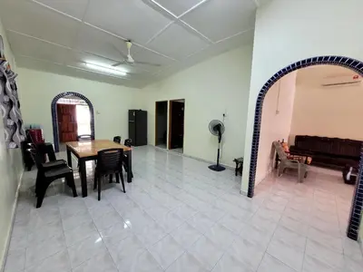 a living room with a table and chairs and a couch at Pangkor Homestay in Pangkor