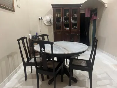 a dining room table with two chairs and a table and a cabinet at Airis Homestay Bertam Perdana in Kepala Batas