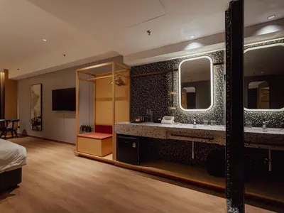 a bathroom with two sinks and a large mirror at Break & Stay formerly known as BreakX Hotel in George Town