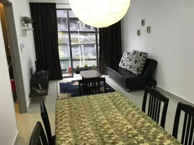 a living room with a table and a couch at Opah Palas Homestay in Brinchang