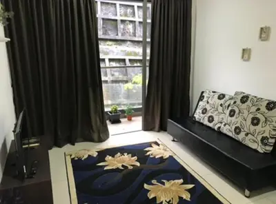 a living room with a couch and a large window at Opah Palas Homestay in Brinchang