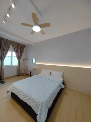 a bedroom with a bed with a ceiling fan at MujiStyle Brinchang Emerald Apartment Cameron 8guests 3bedrooms3bathroom in Brinchang