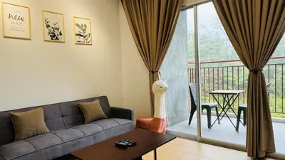 a living room with a couch and a table and a balcony at MujiStyle Brinchang Emerald Apartment Cameron 8guests 3bedrooms3bathroom in Brinchang