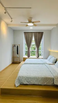 a bedroom with a large bed and a window at MujiStyle Brinchang Emerald Apartment Cameron 8guests 3bedrooms3bathroom in Brinchang